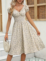 Beige floral print midi dress with short sleeves and V-neck, showcasing an elegant and feminine style.