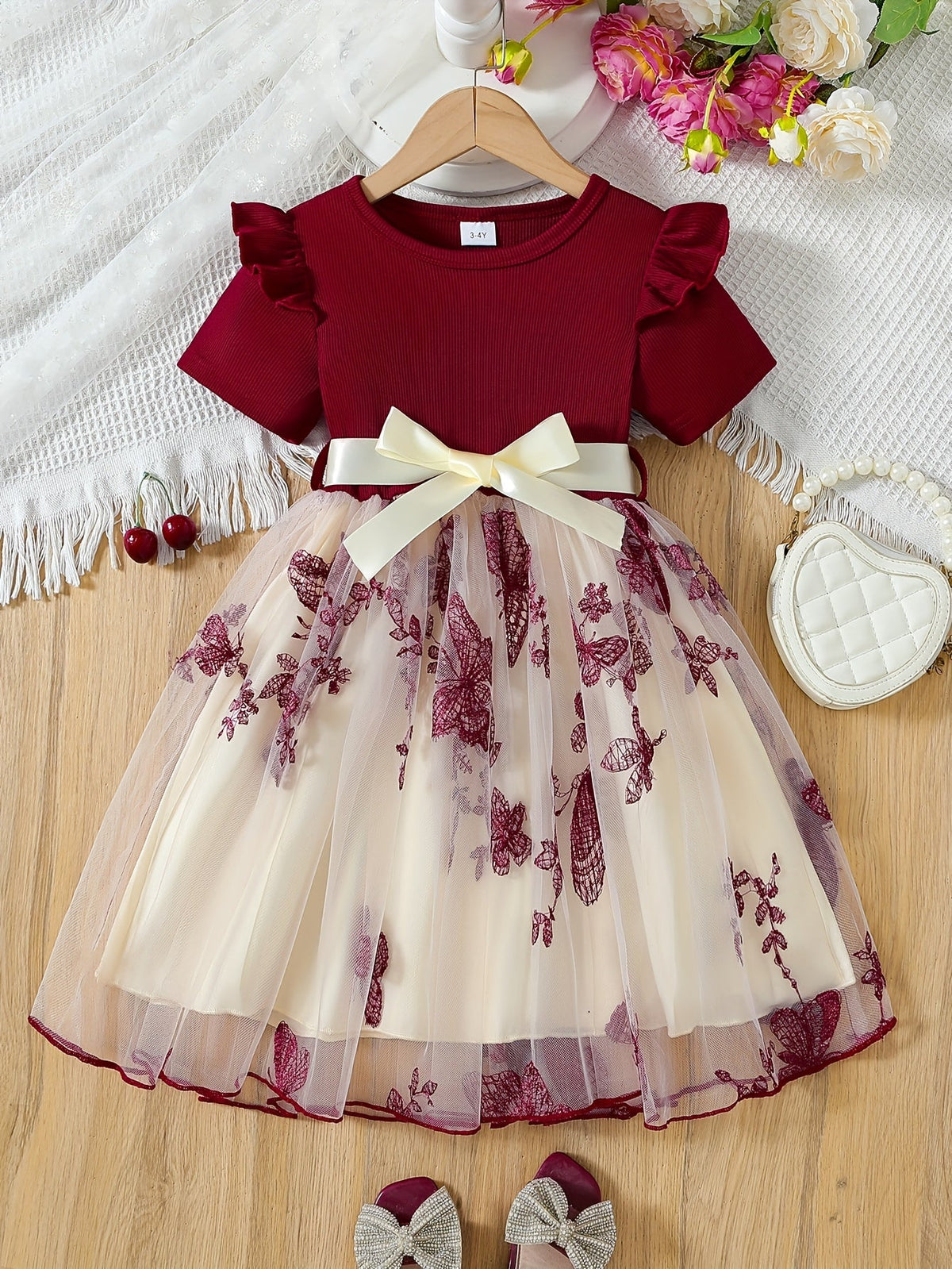 Elegant short-sleeved tutu dress with bow and mesh details for girls.